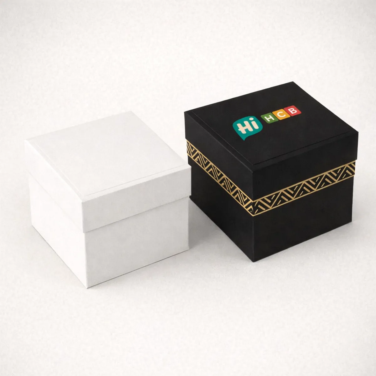 Two square rigid gift boxes featuring detachable lids- gold geometric patterns- and a custom logo- class=